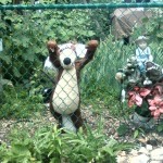 stuffed animal trying to climb over fence